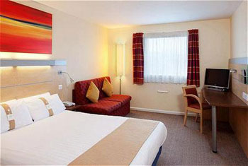 Book a room at the Holiday Inn Express Cardiff airport A bedroom at the Holiday Inn Express Cardiff airport.